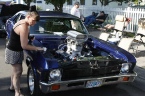 Toni Gonzales of Veneta, Oregon, cleans her 1971 Chevrolet Nova, at the Function 4 Junction in Junction City, Oregon June 4, 2016